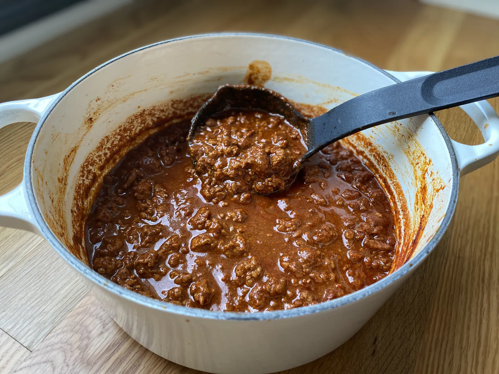 A pot of Pecos Red chili with a ladle