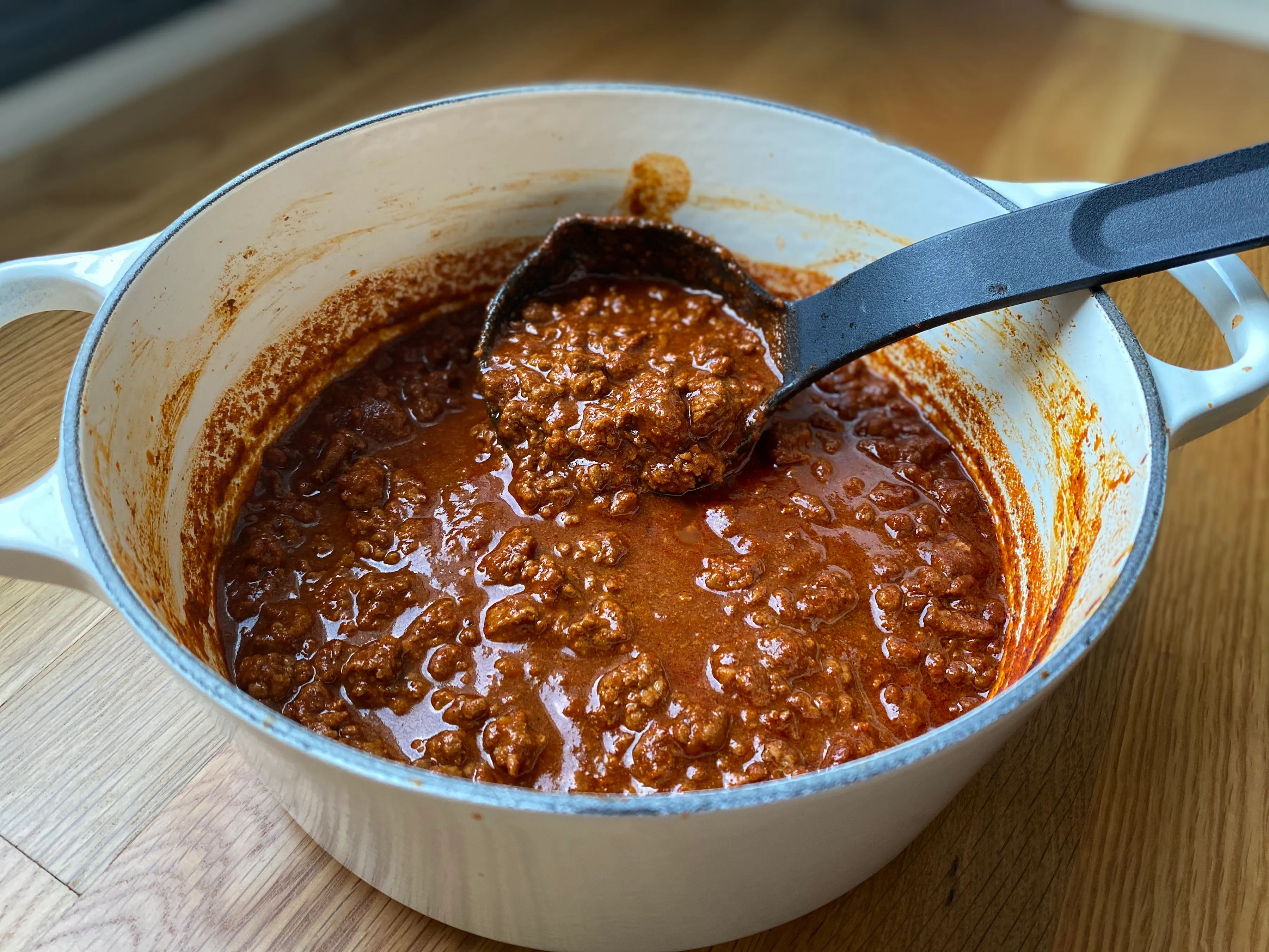 A pot of Pecos Red chili with a ladle