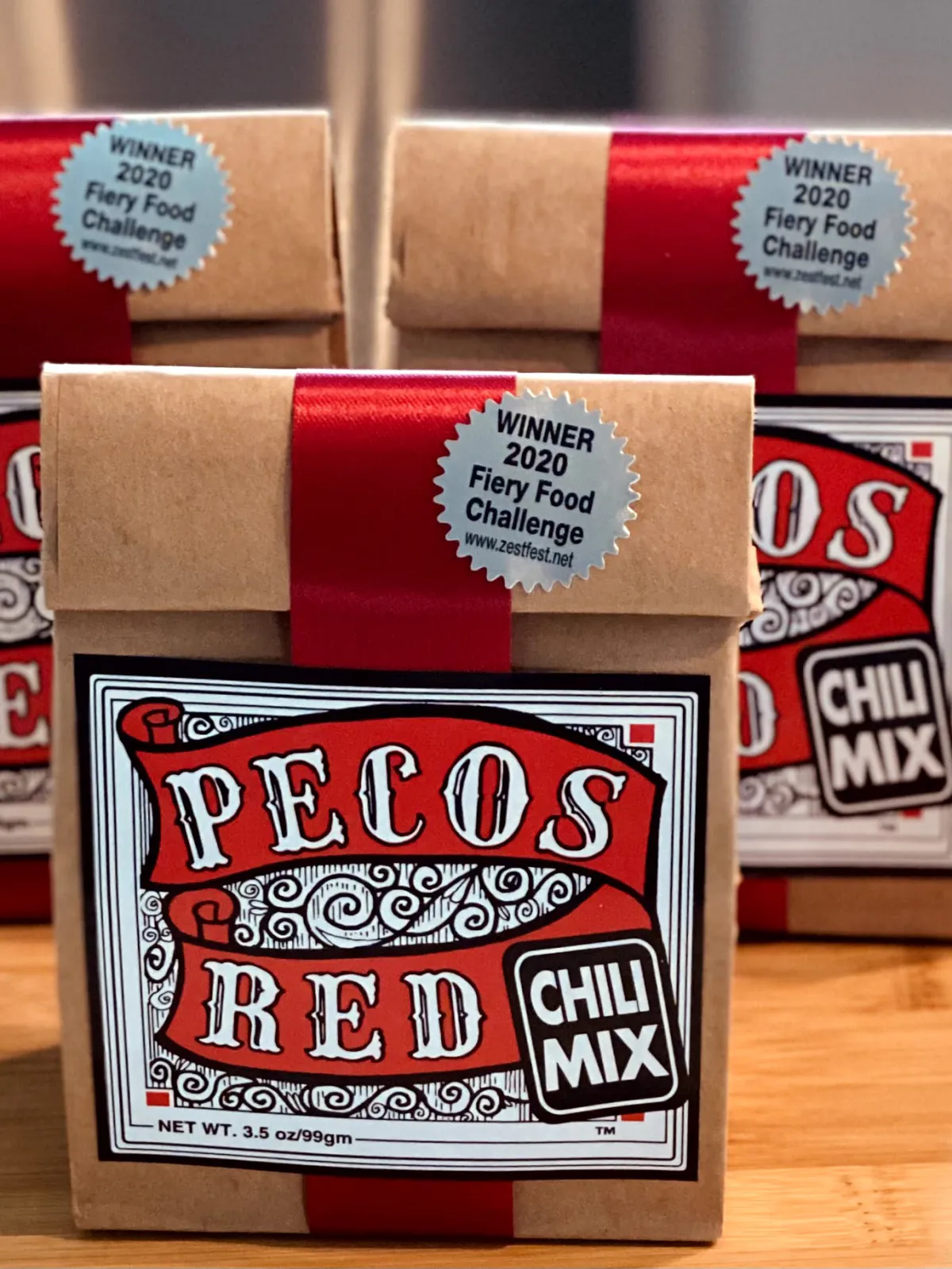 Pecos Red Chili Mix — kraft bags with red ribbon and award seals