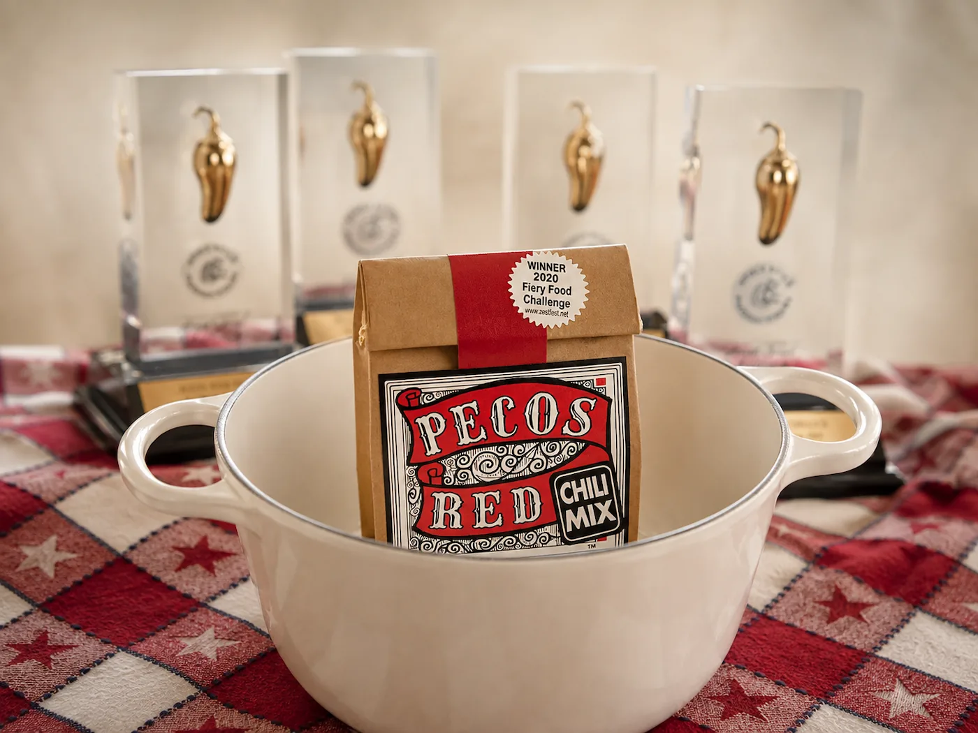 Pecos Red Chili Mix in a white pot with trophies in the background