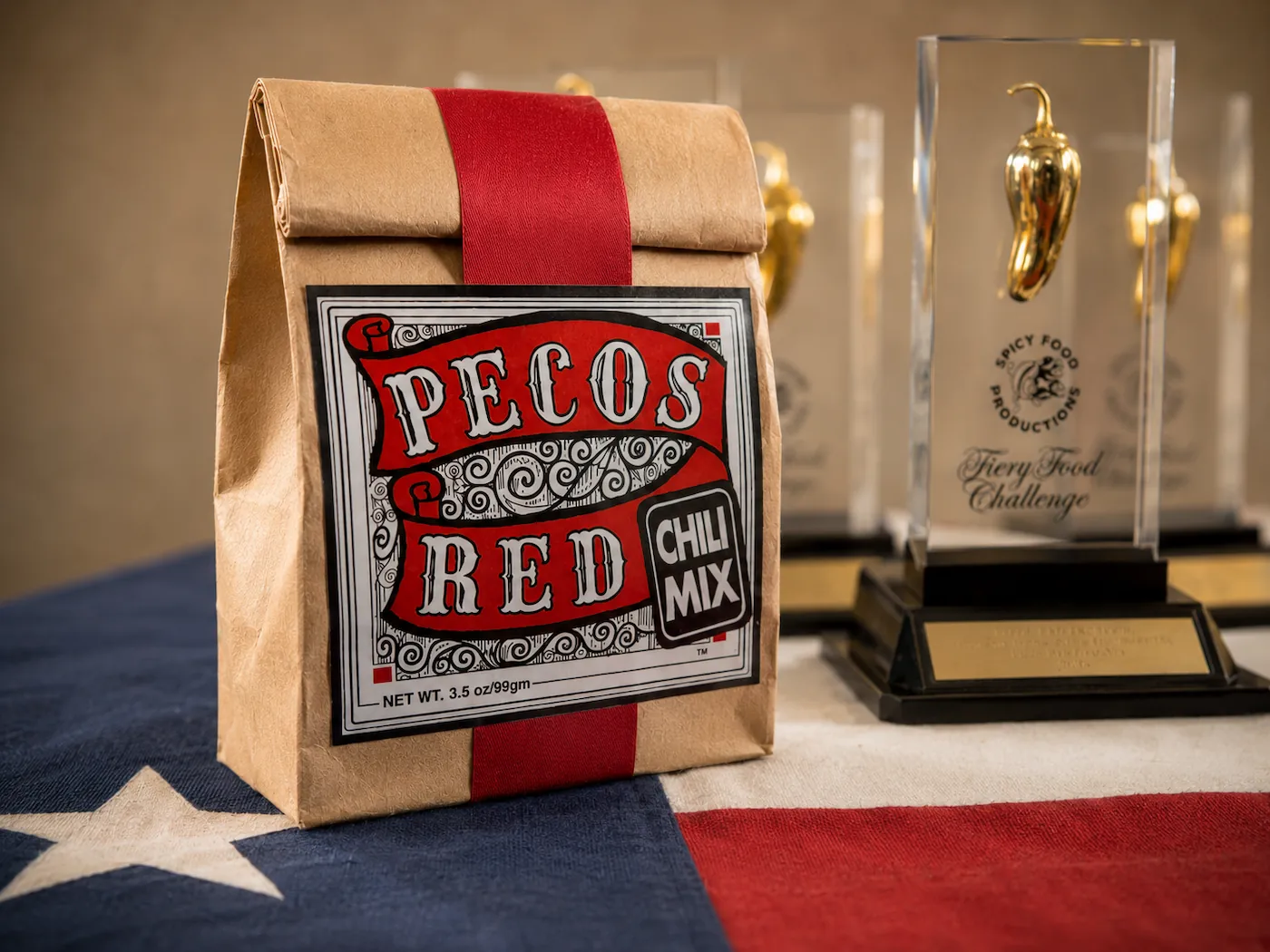 Pecos Red Chili Mix on Texas flag with trophies in the background