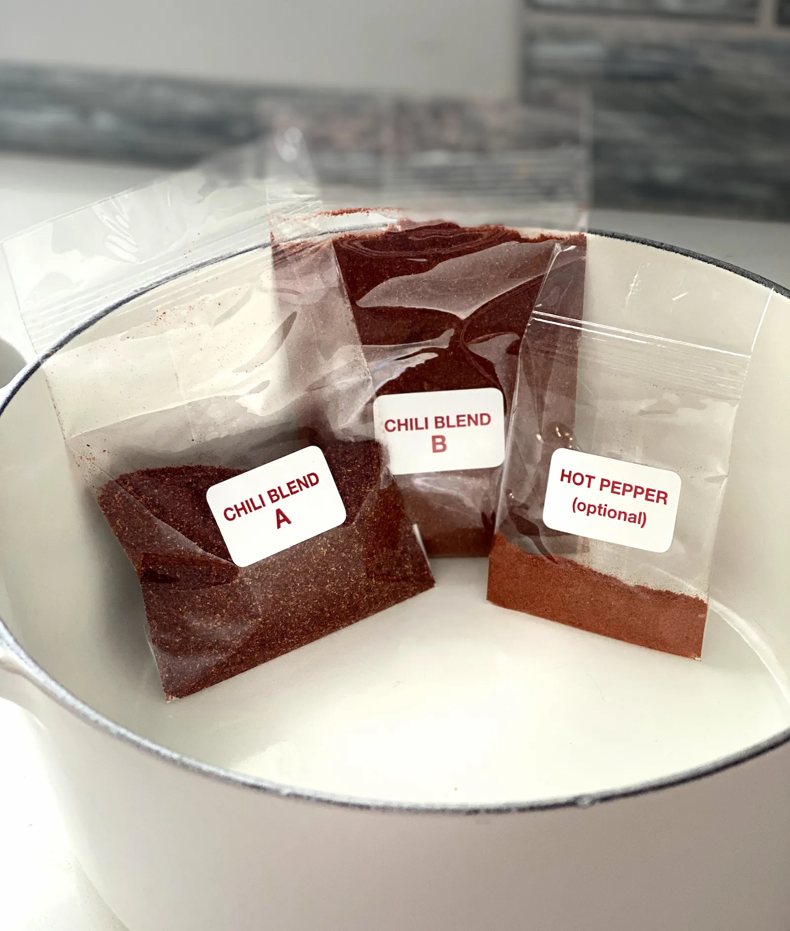 Pecos Red Chili Mix spice packets inside a white pot